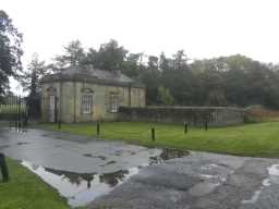 Oblique view of East Lodge, connecting wall and gates to Streathlam Castle October 2016